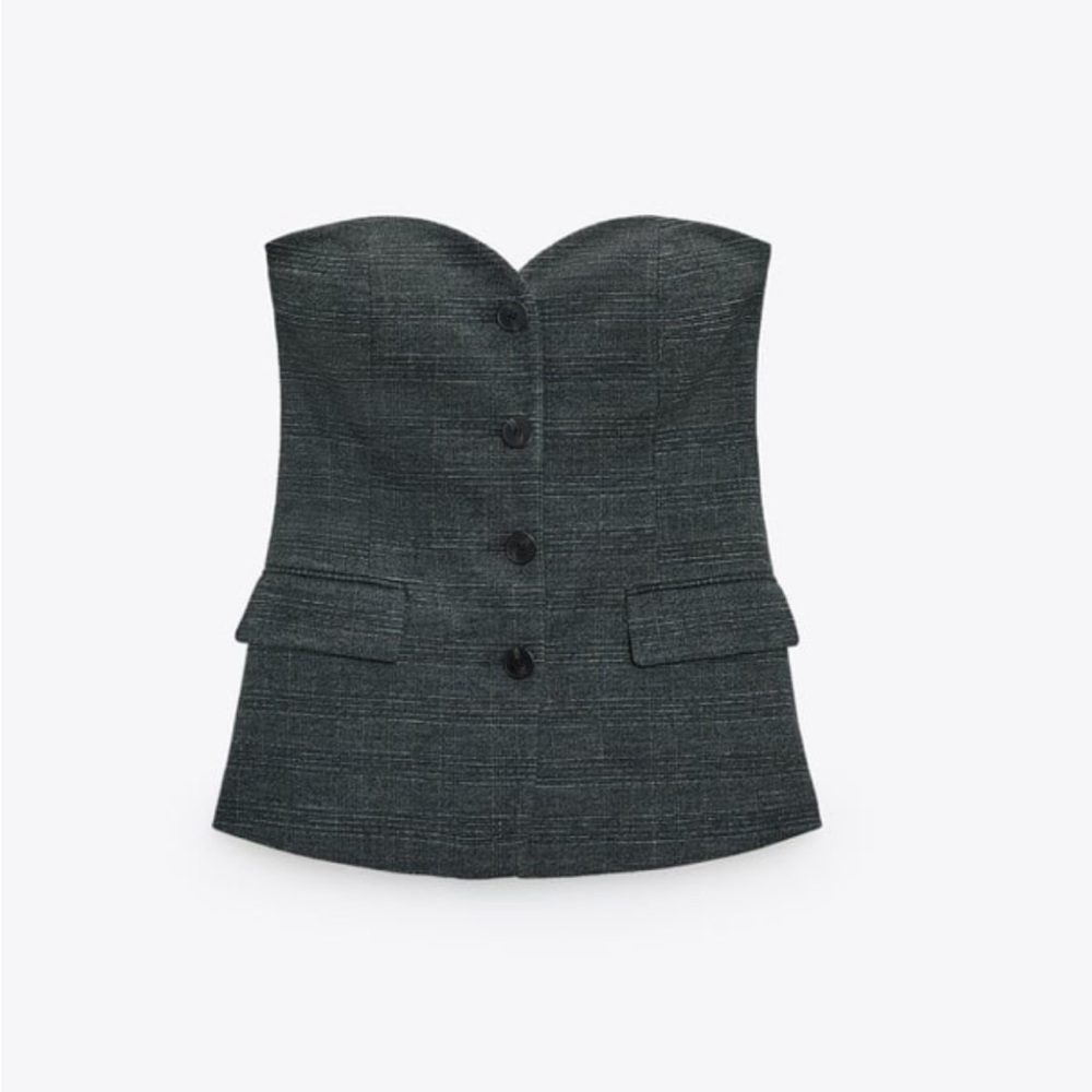 Bustier vest with sweetheart neckline and front laps. Front button closure.